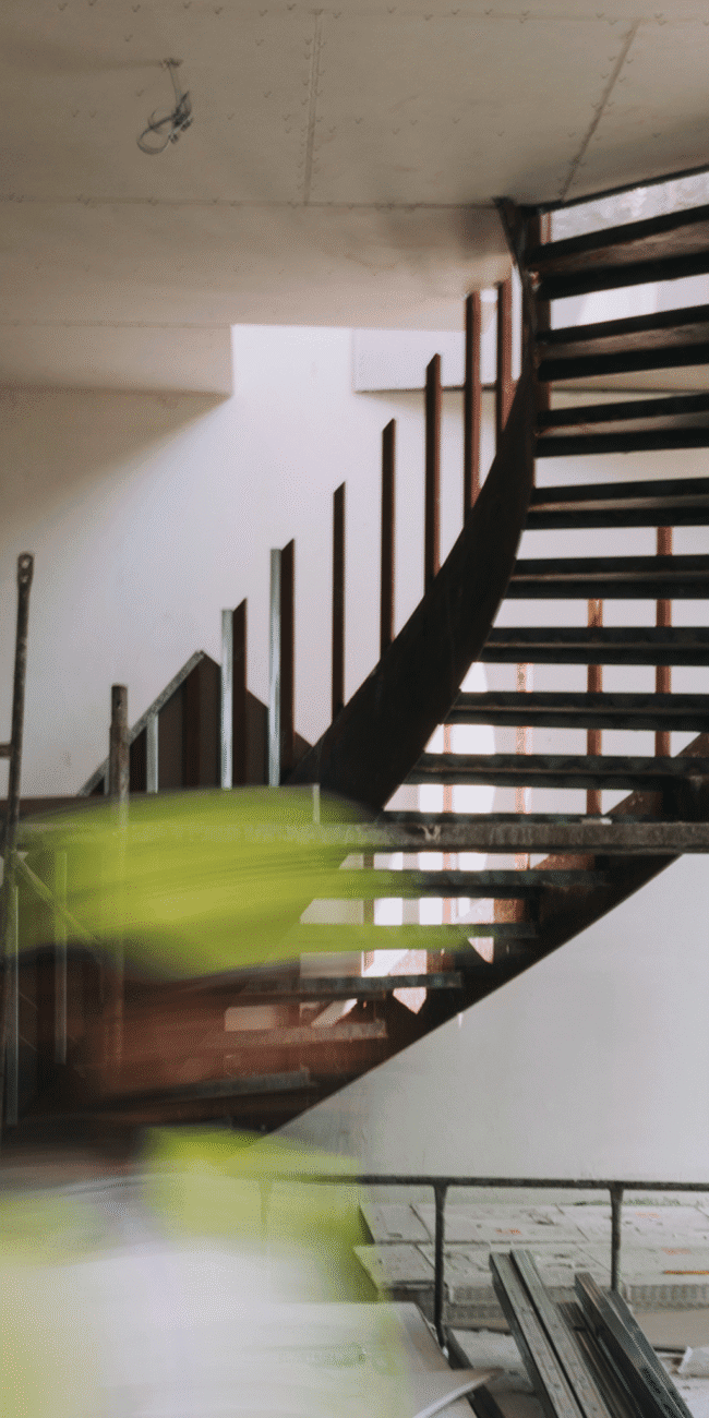 Modern wooden staircase interior under construction at Olivehue Interiors.