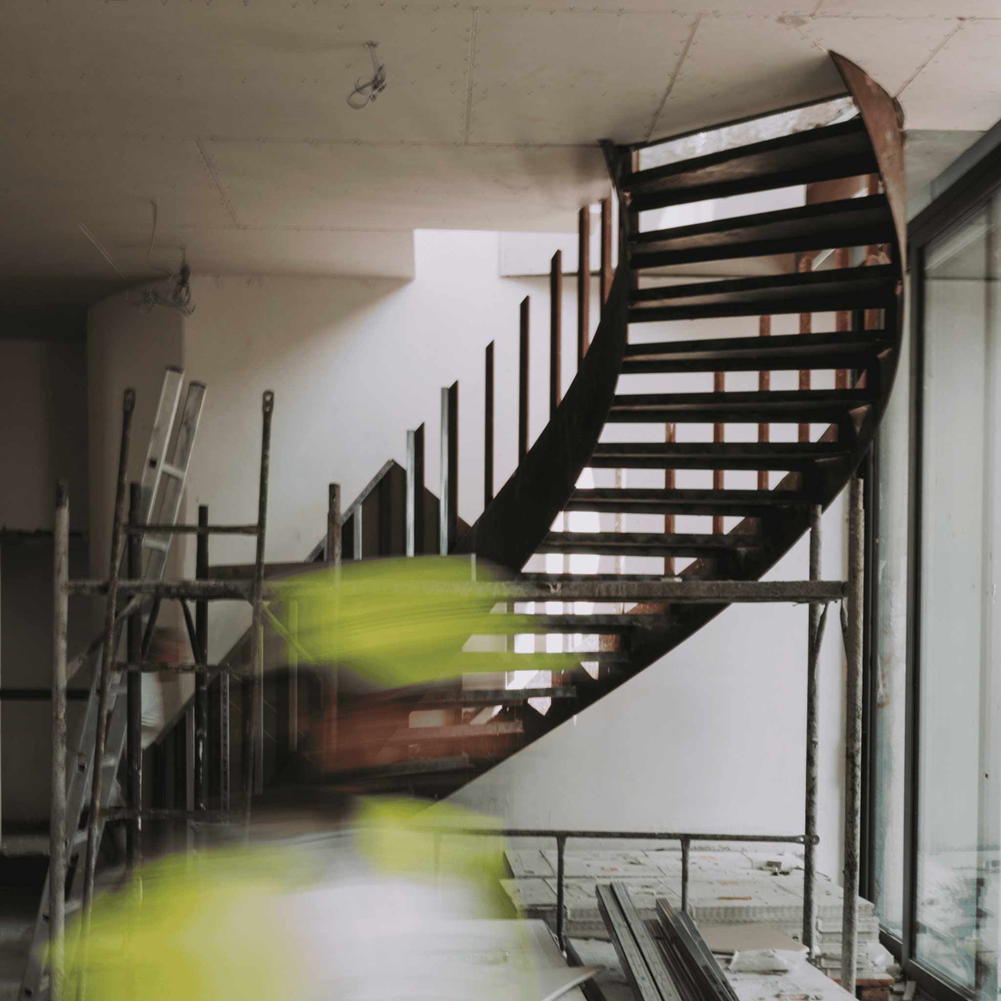Modern wooden staircase interior under construction at Olivehue Interiors.