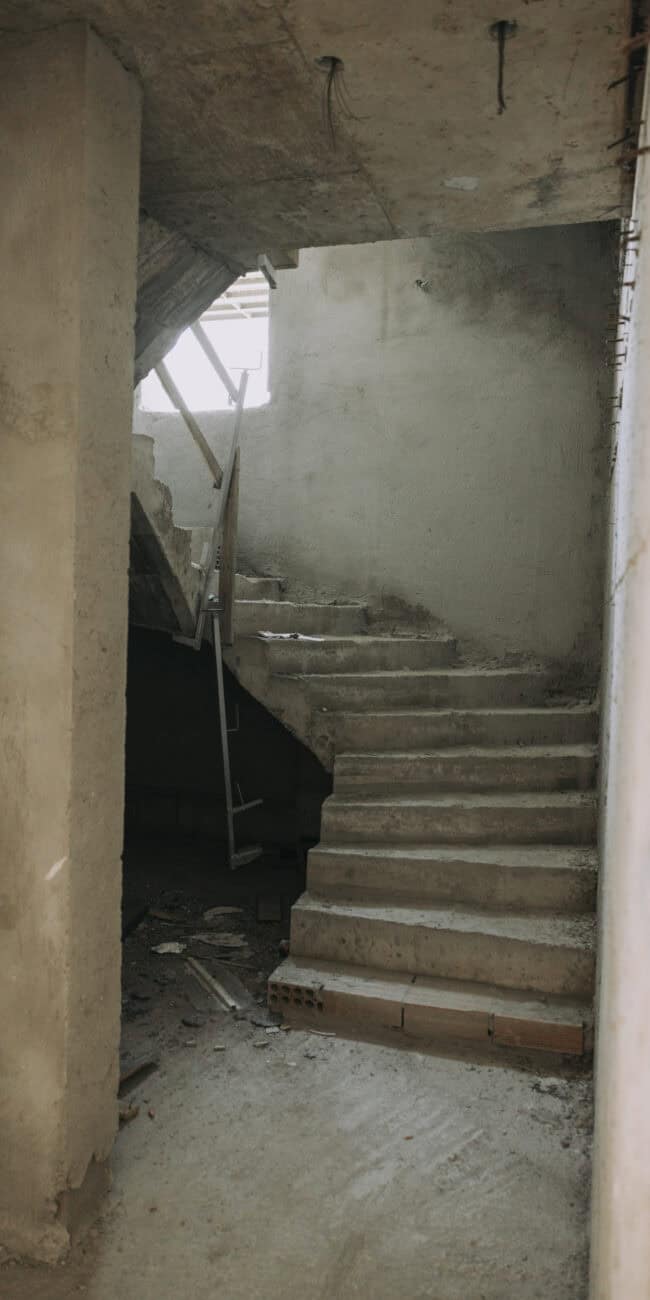 Unfinished concrete staircase in a newly constructed interior space.