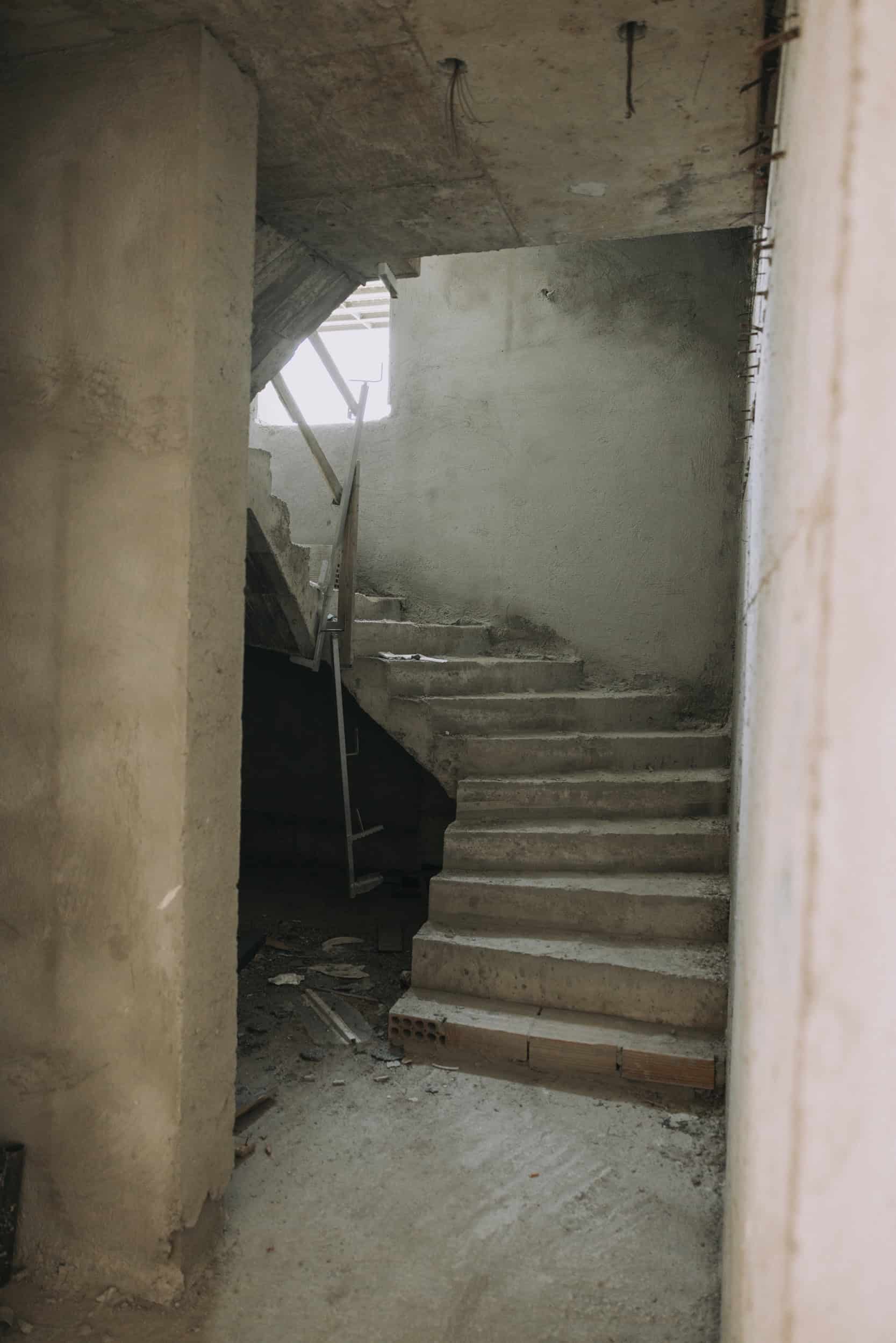 Unfinished concrete staircase in a newly constructed interior space.