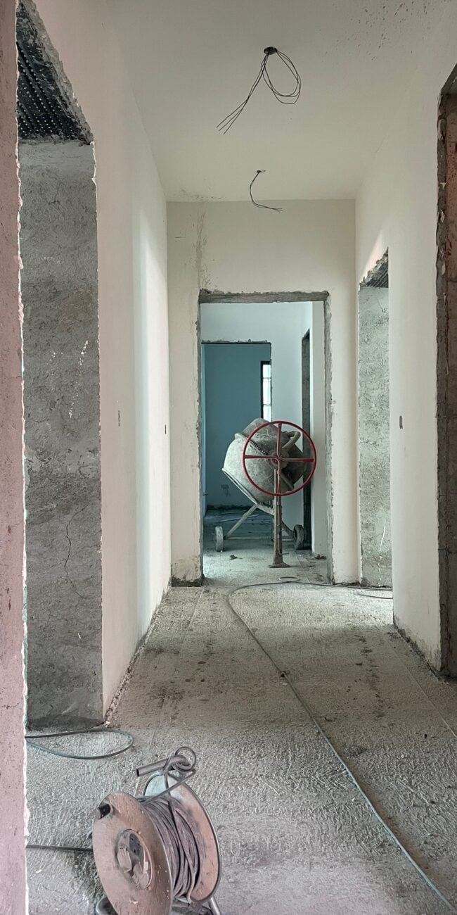 Construction hallway with unfinished walls and ceiling, highlighting interior renovation and home remodeling services.