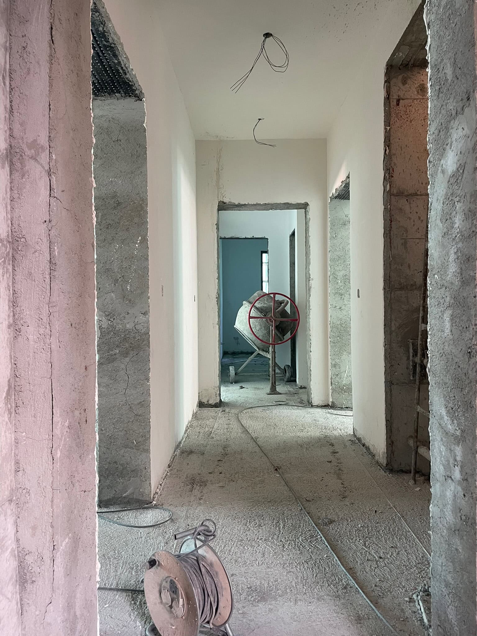 Construction hallway with unfinished walls and ceiling, highlighting interior renovation and home remodeling services.